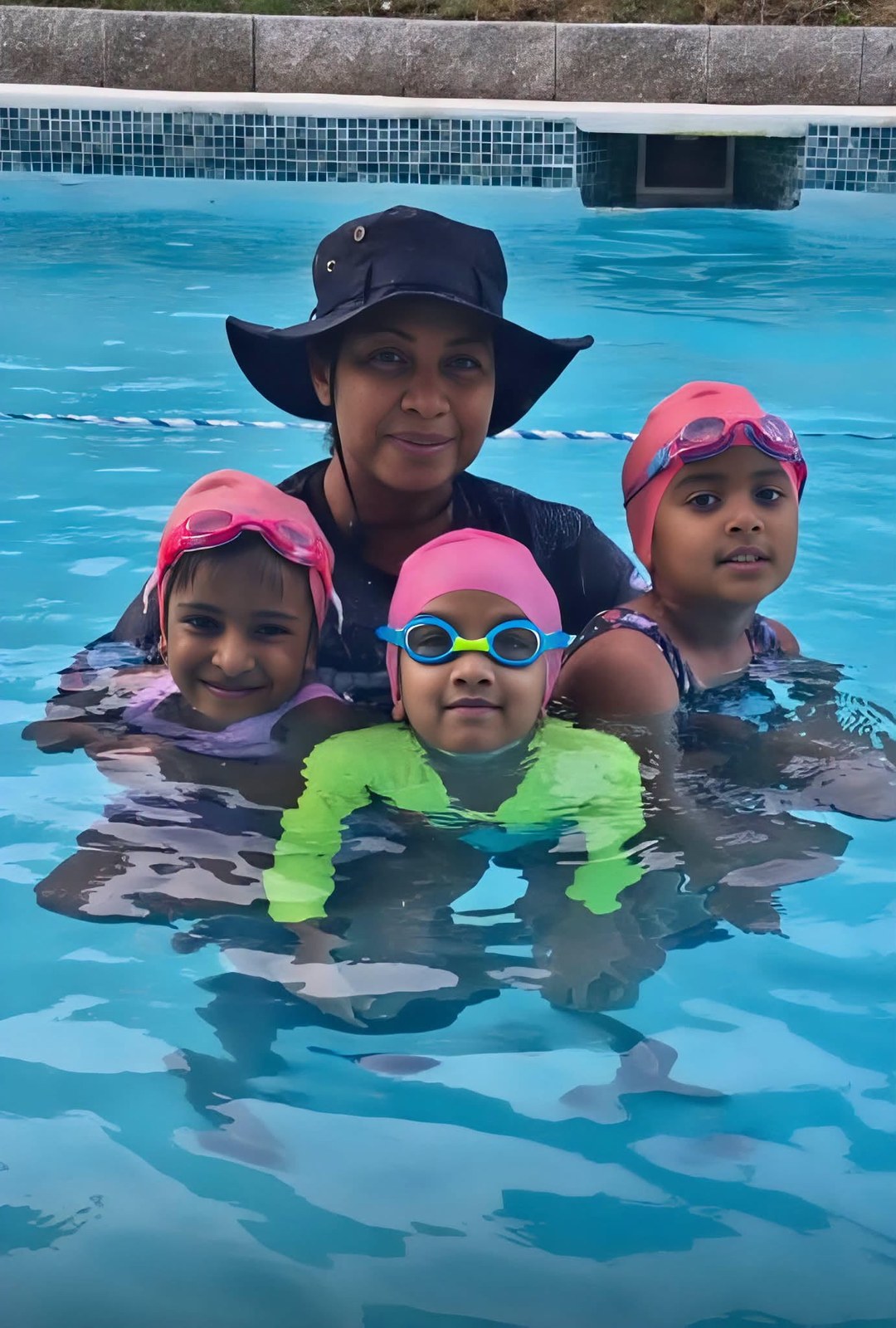 Swimming instructor with young swimmers in a pool